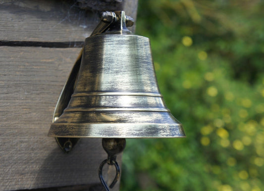 Hanging Antique Brass Boat Bell on Exterior Wall