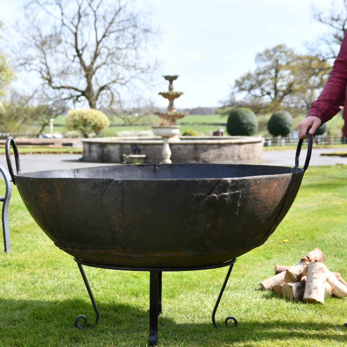 120cm Kadai Fire Bowl in Garden Setting with Handles Up 