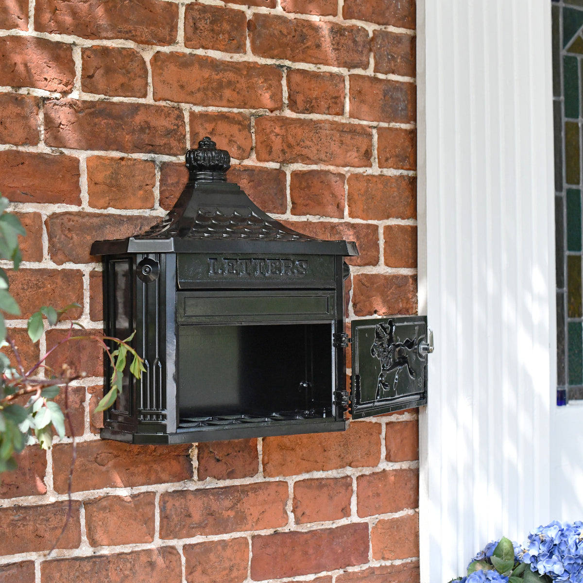 The traditional post box with its hinged door open 