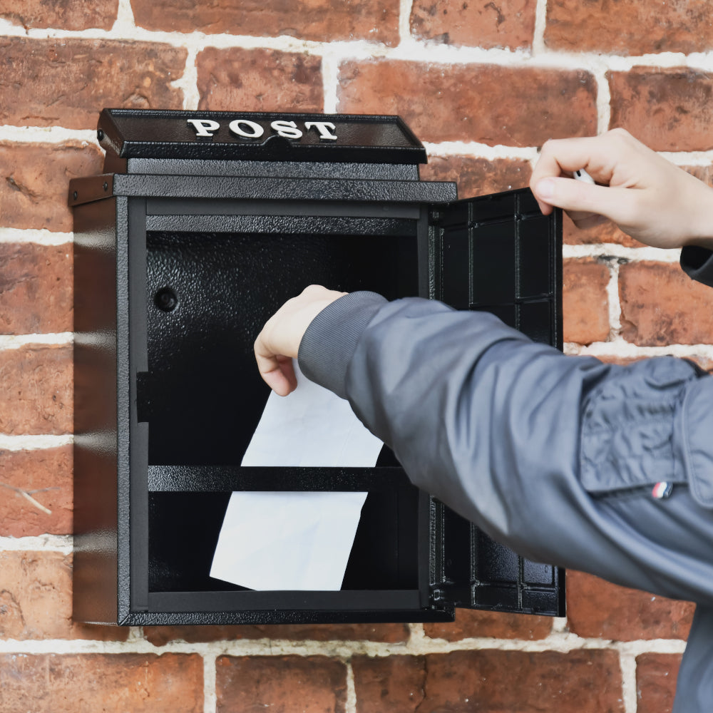 Mail being retrieved from the post box