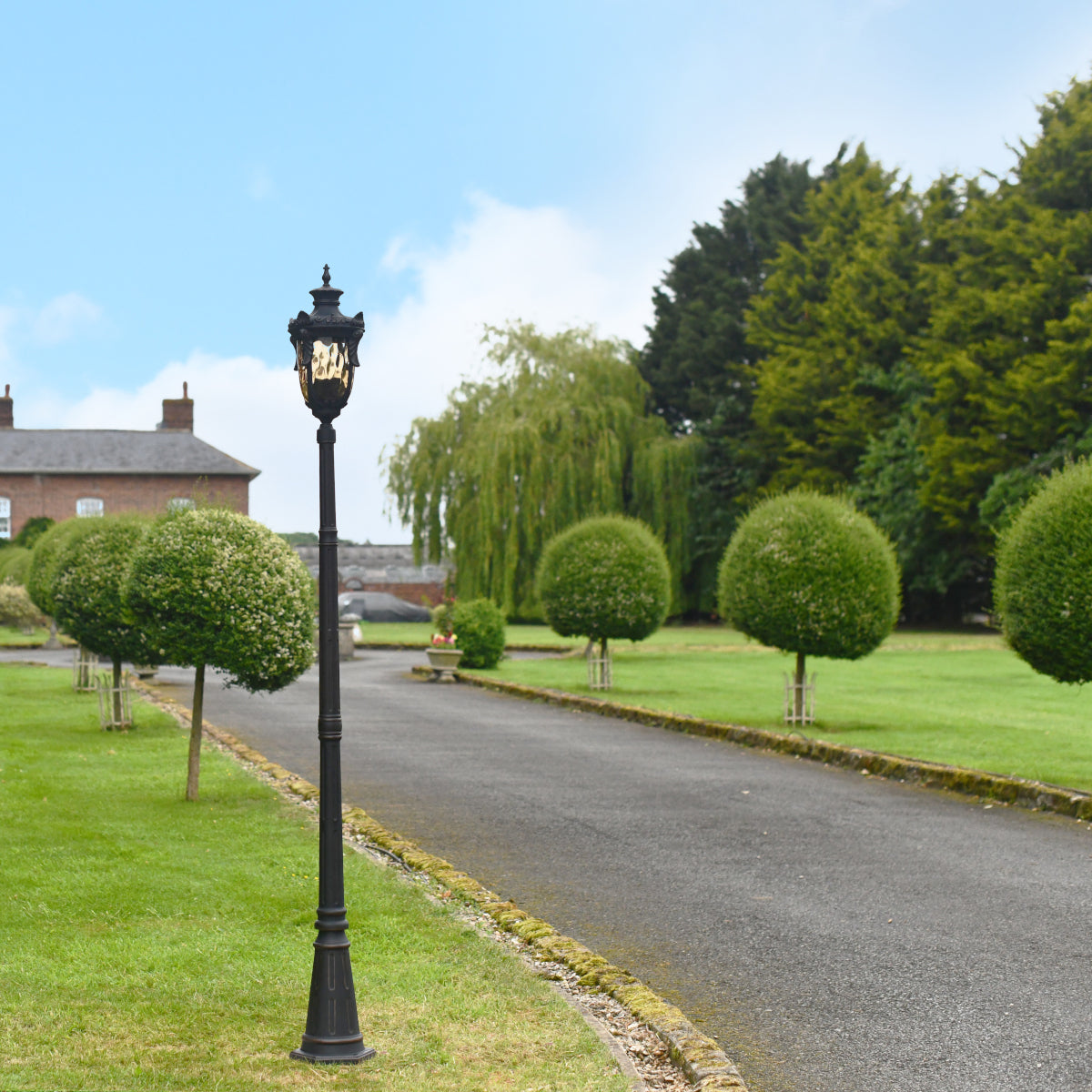 The old bronze lamp post situated on a driveway