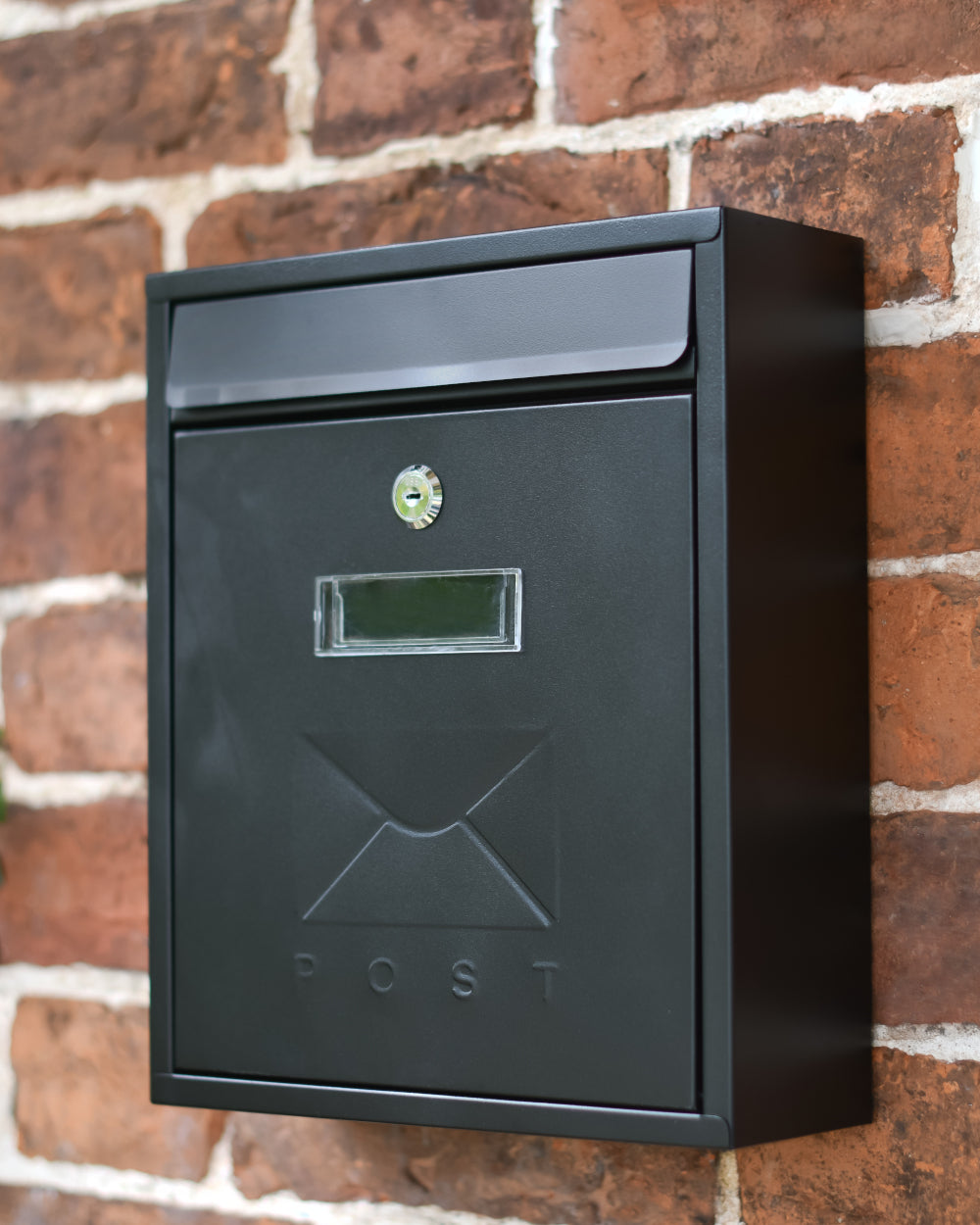 Black wall-mounted post box 