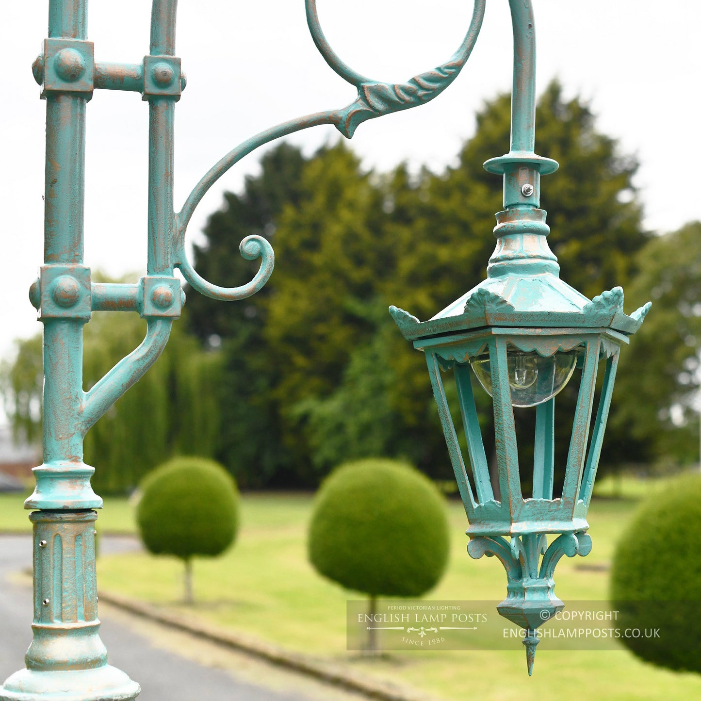 Antique Blue Sixed Sided Lantern Suspended From Swan Neck Lantern Bracket