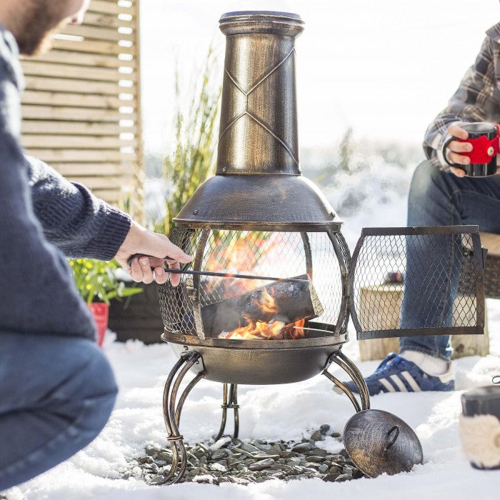 Traditional Antique Bronze Finish Chimenea in Use Burning Wood
