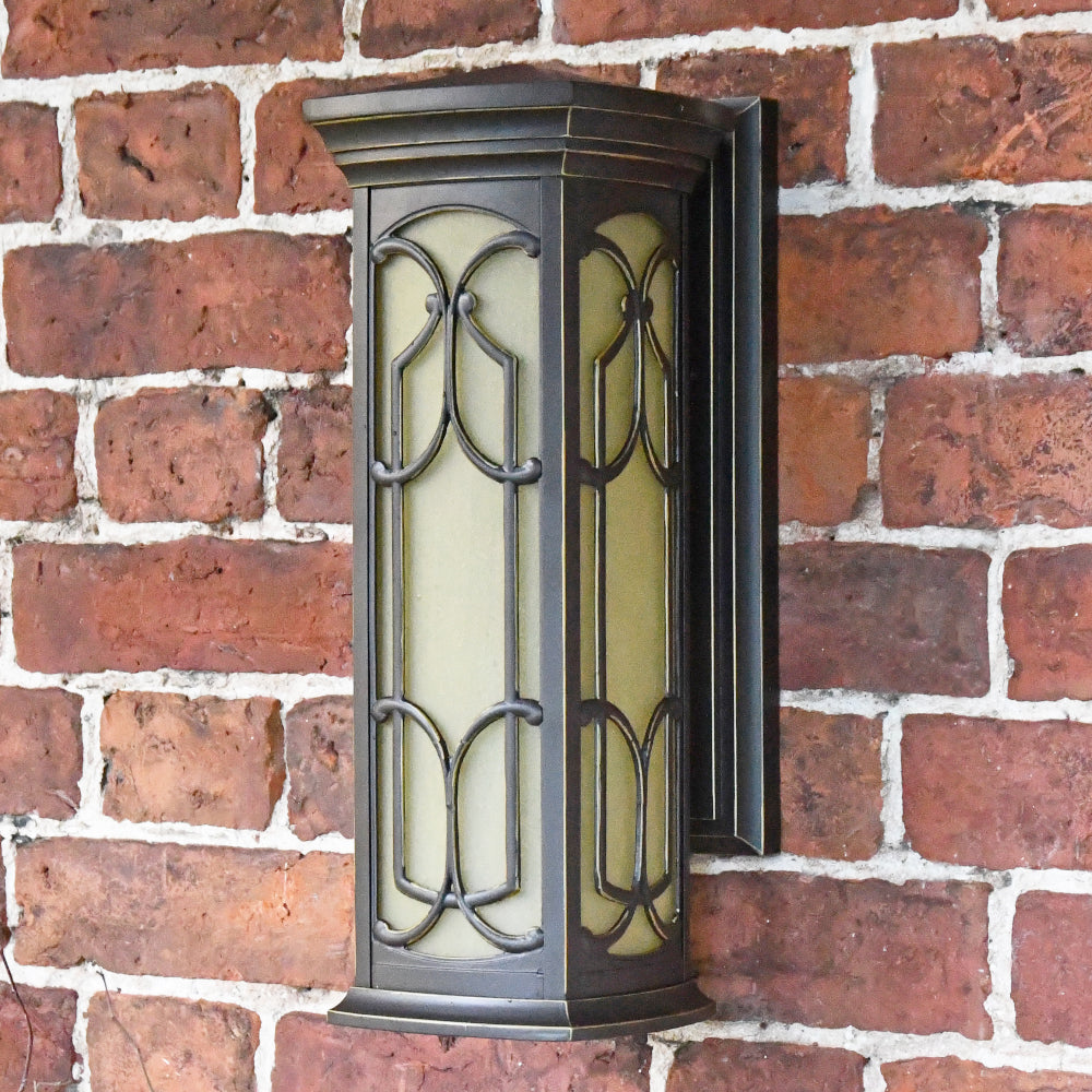The antique bronze wall light mounted to the wall 