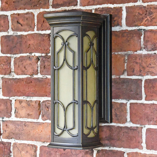 The antique bronze wall light mounted to the wall 