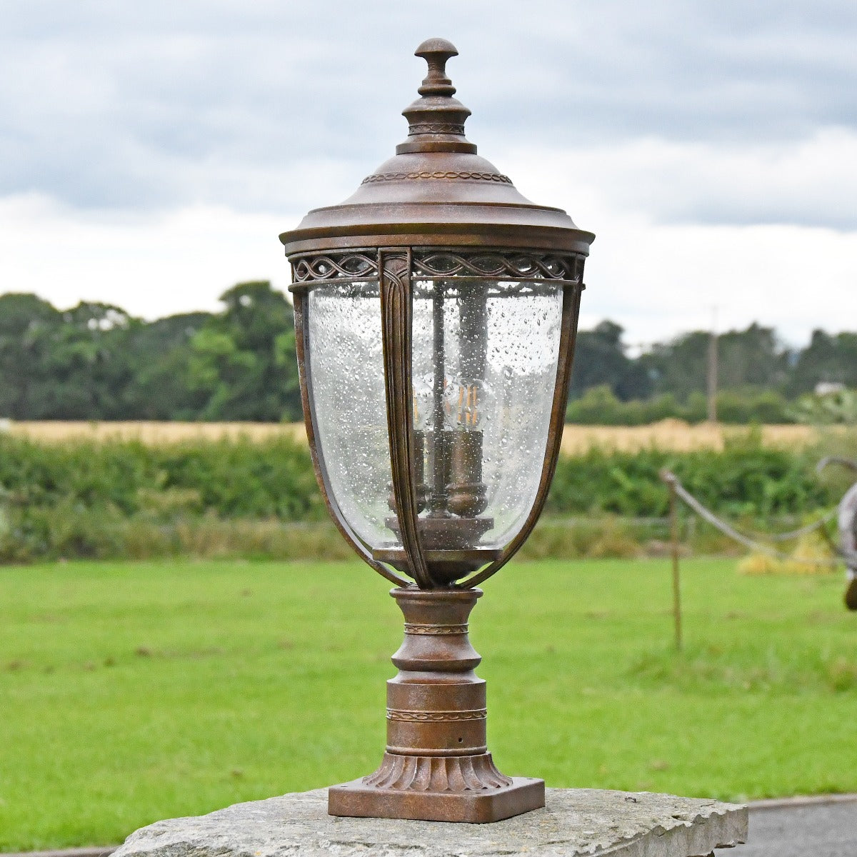 Antique Bronze Pillar Post Light In Garden Setting