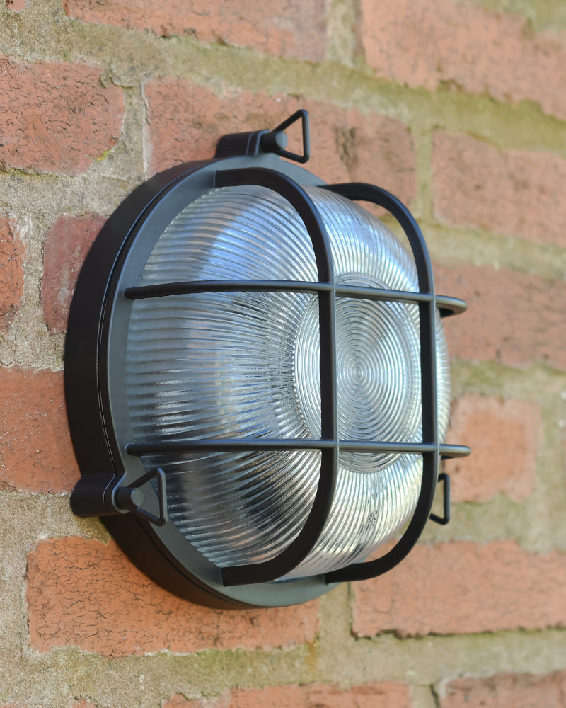 Flush fit wall mountable lantern in a caged frame
