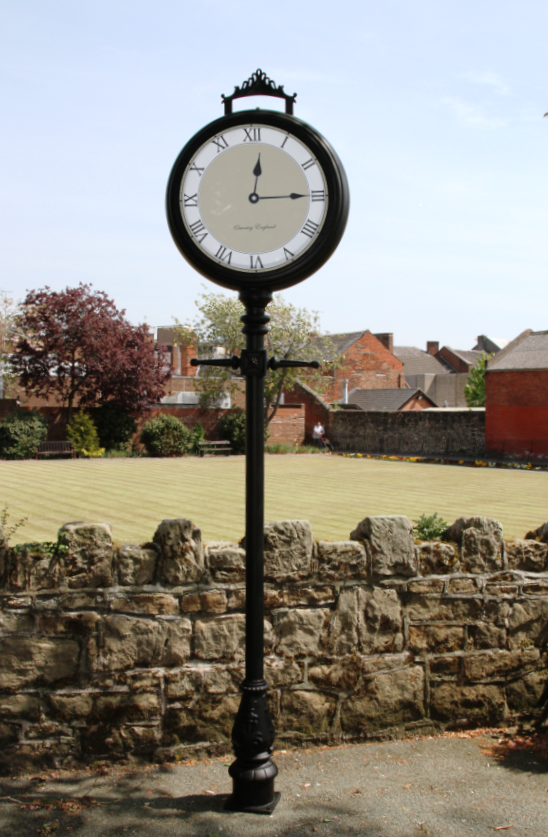 Bespoke lamp post clock in front of field