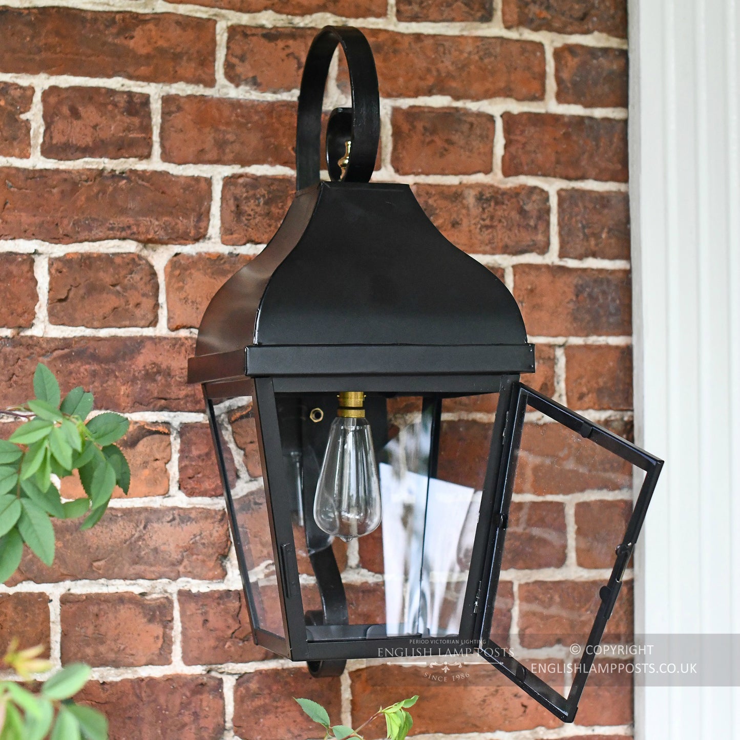 Black Traditional Wall Lantern Installed In Front Porch