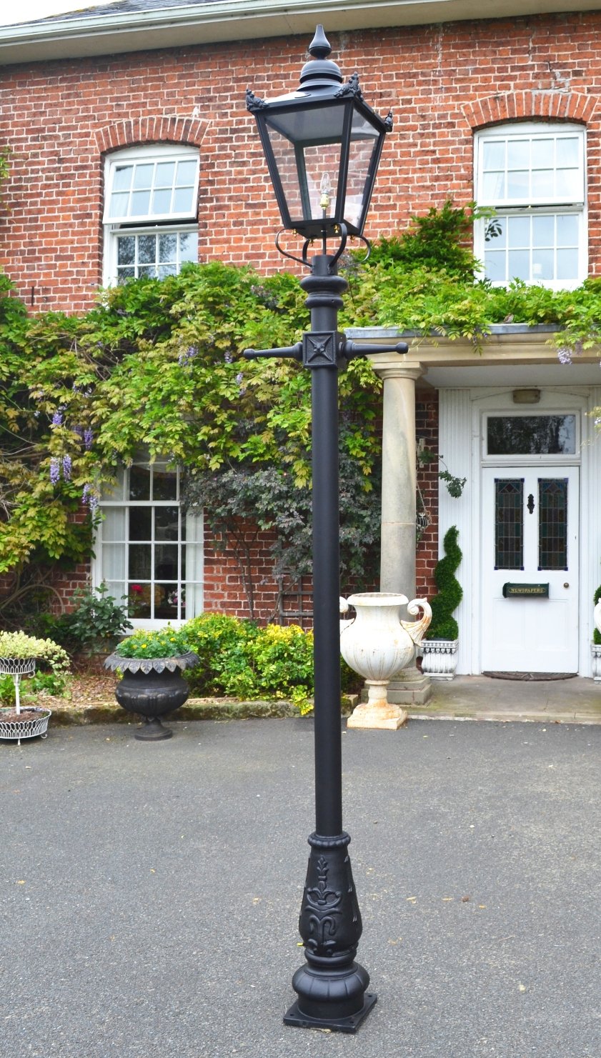 Traditional Victorian Lamp Post in front of a gardens flower bed
