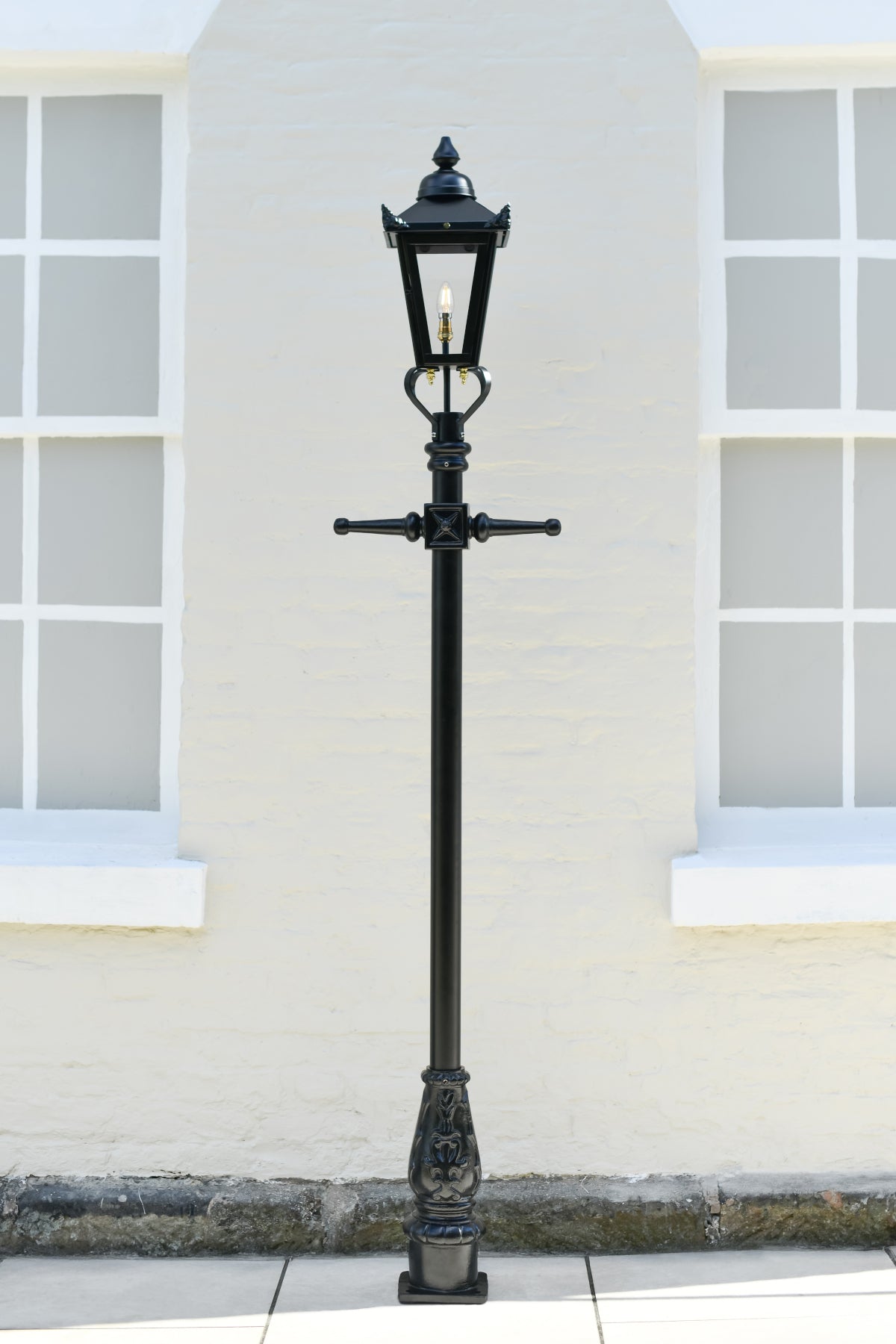 Black Victorian Lamp Posts In a Garden Setting