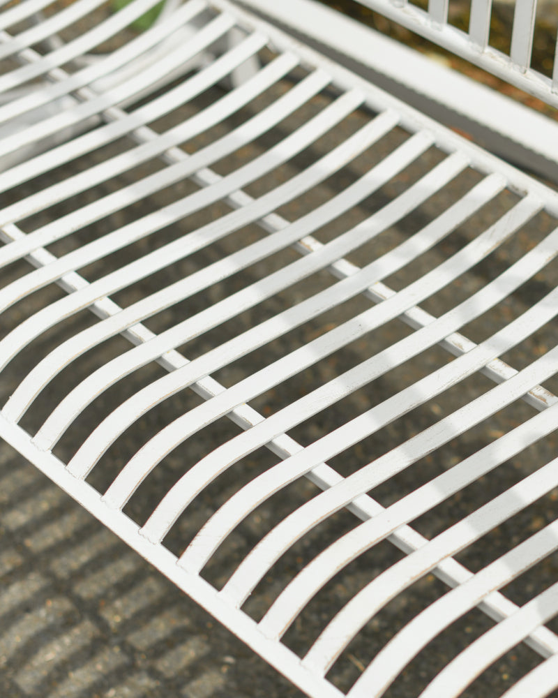 The white metal bench seat