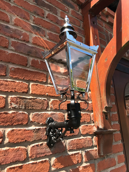 Bright Chrome Kensington Wall Light under a patio