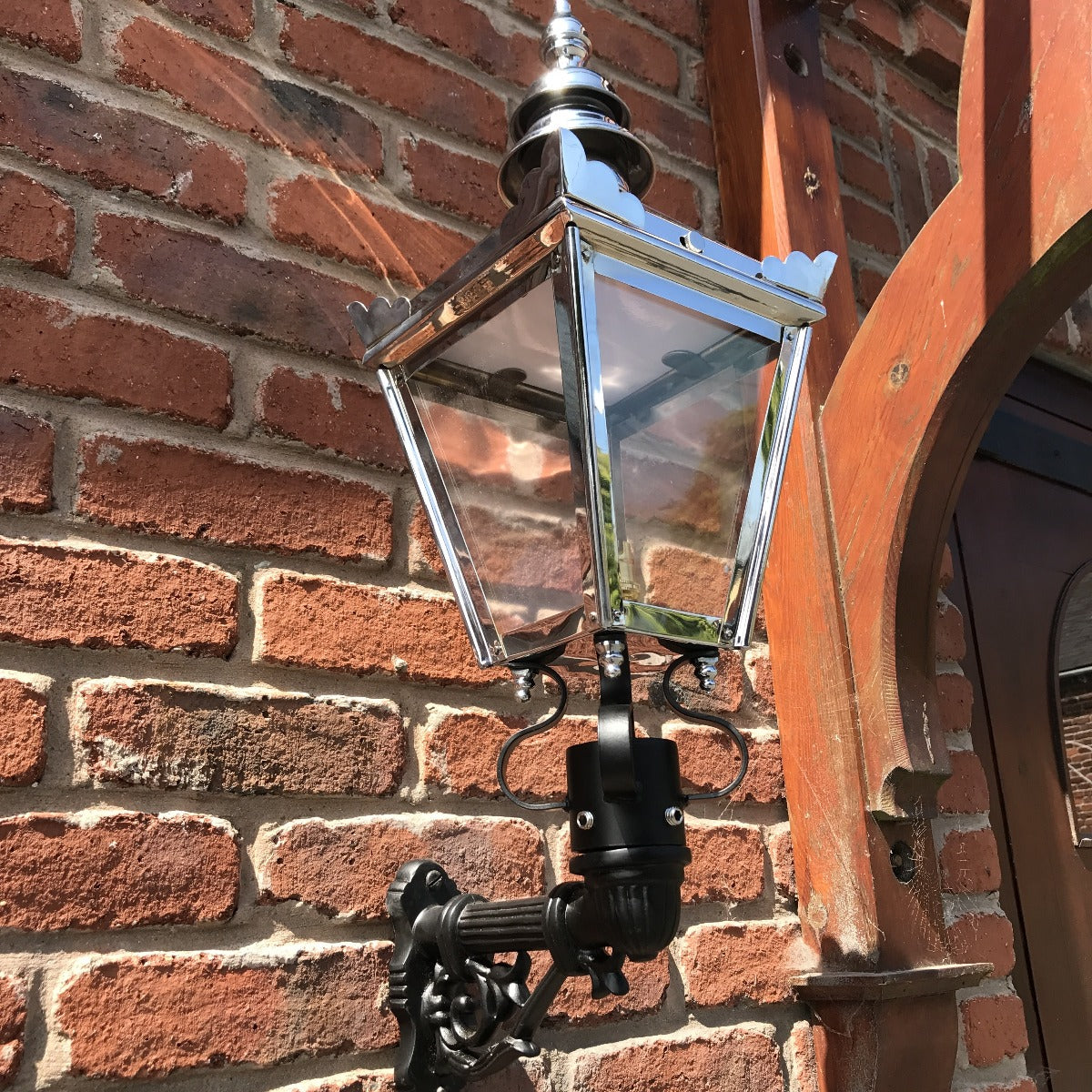 Bright Chrome Kensington Wall Light On Brick Wall