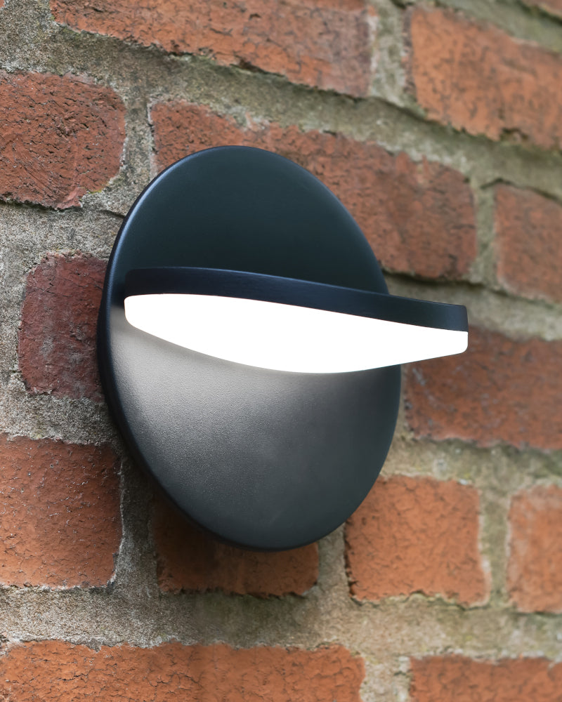 Angled view of the LED wall light mounted to a brick wall
