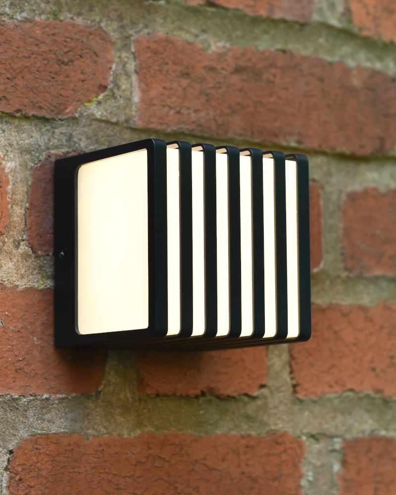 Three quarter view of the modern wall light lit up