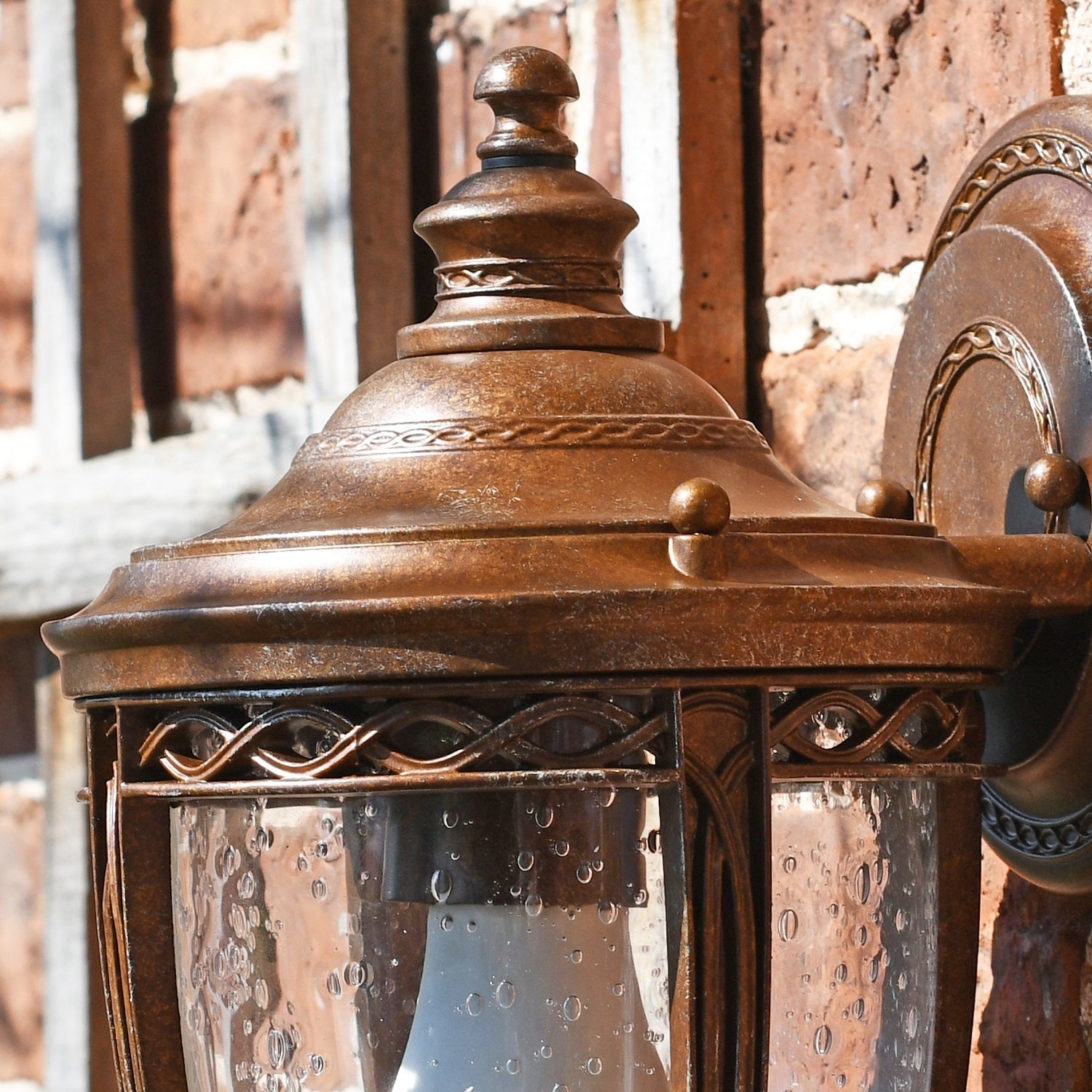 Close up of bronze finish ornate detail on wall mounted lantern