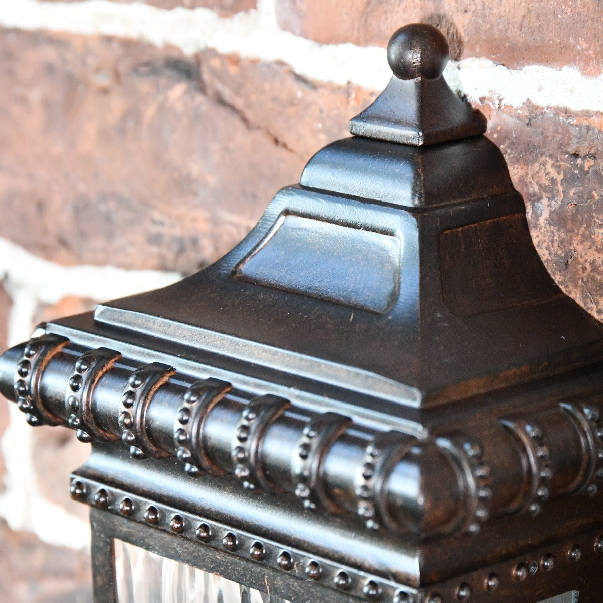 Close Up Of Bronze Wall Light Top Finial