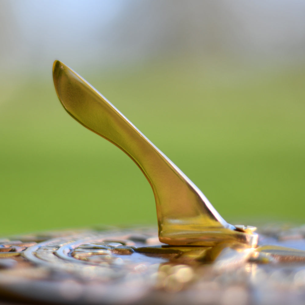 Close up of sundial nomon andtique brass