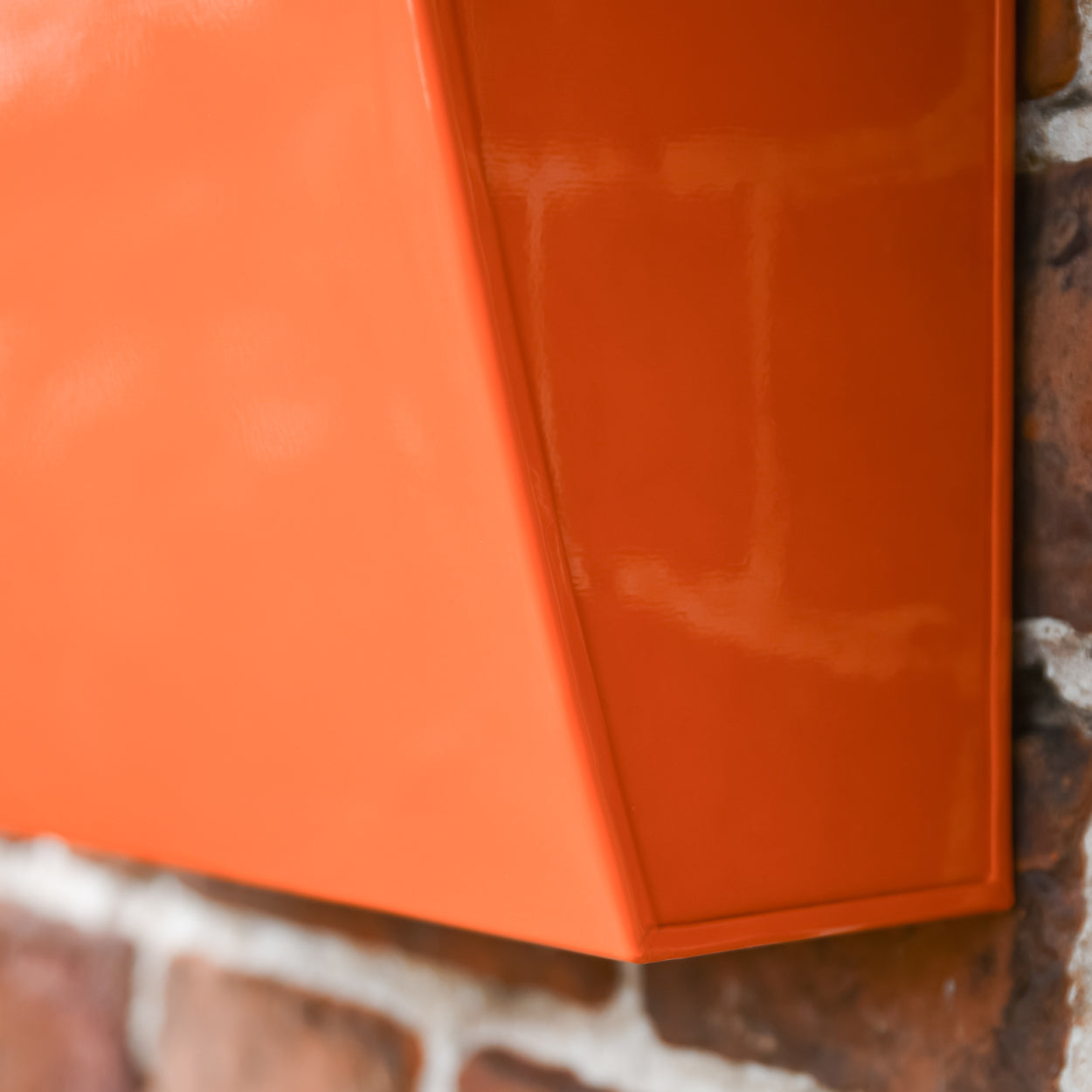 Close up of the 'Montcour' orange post box edge