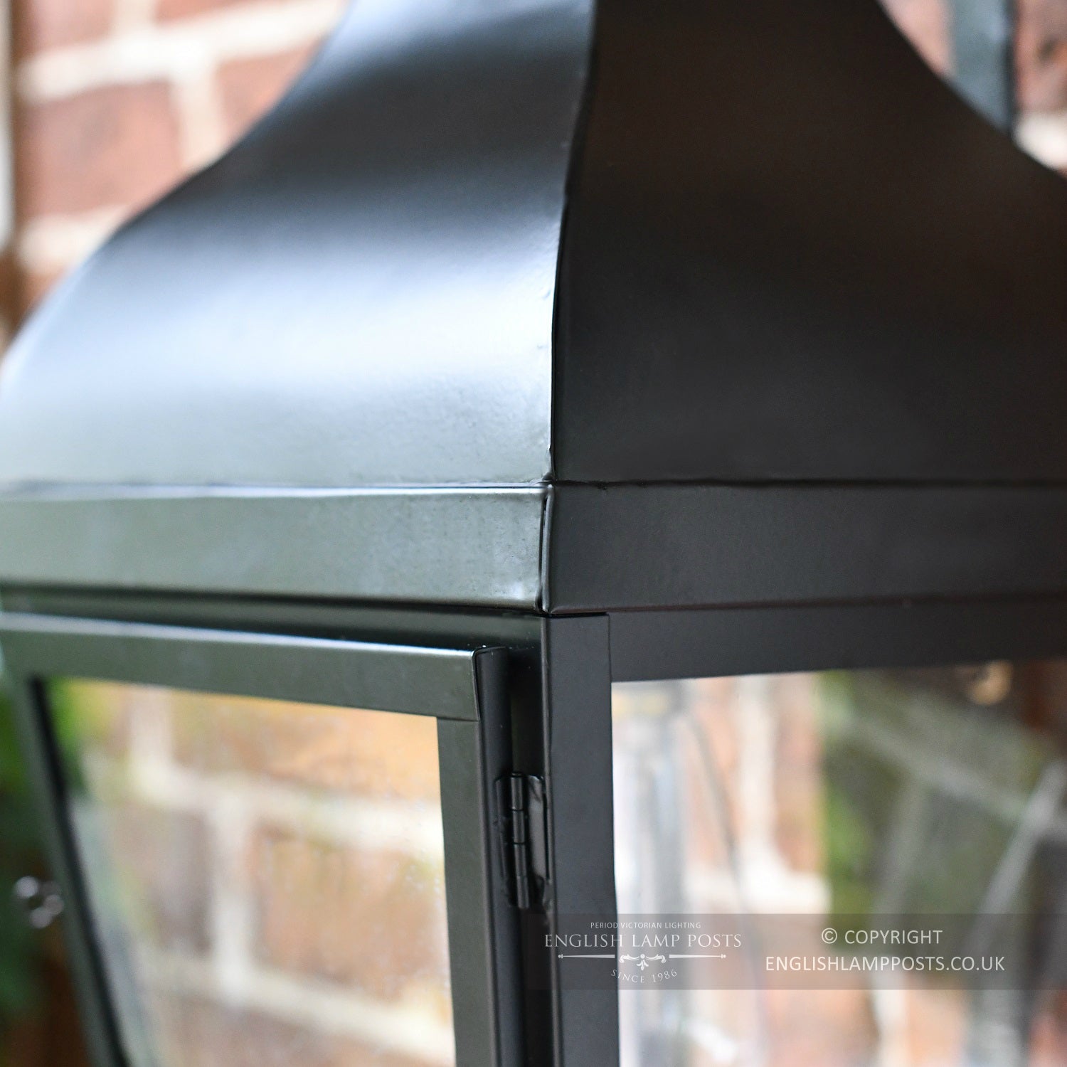 Close Up Of Traditional Black Wall Lantern With Scroll Bracket