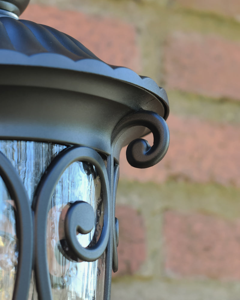 Close view of the coiled decoration around the lantern perimeter