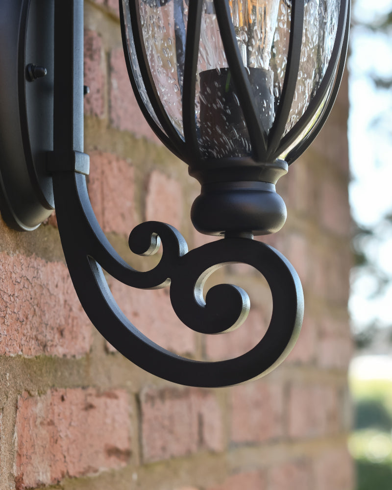 Close view of the ornate bottom arm bracket 