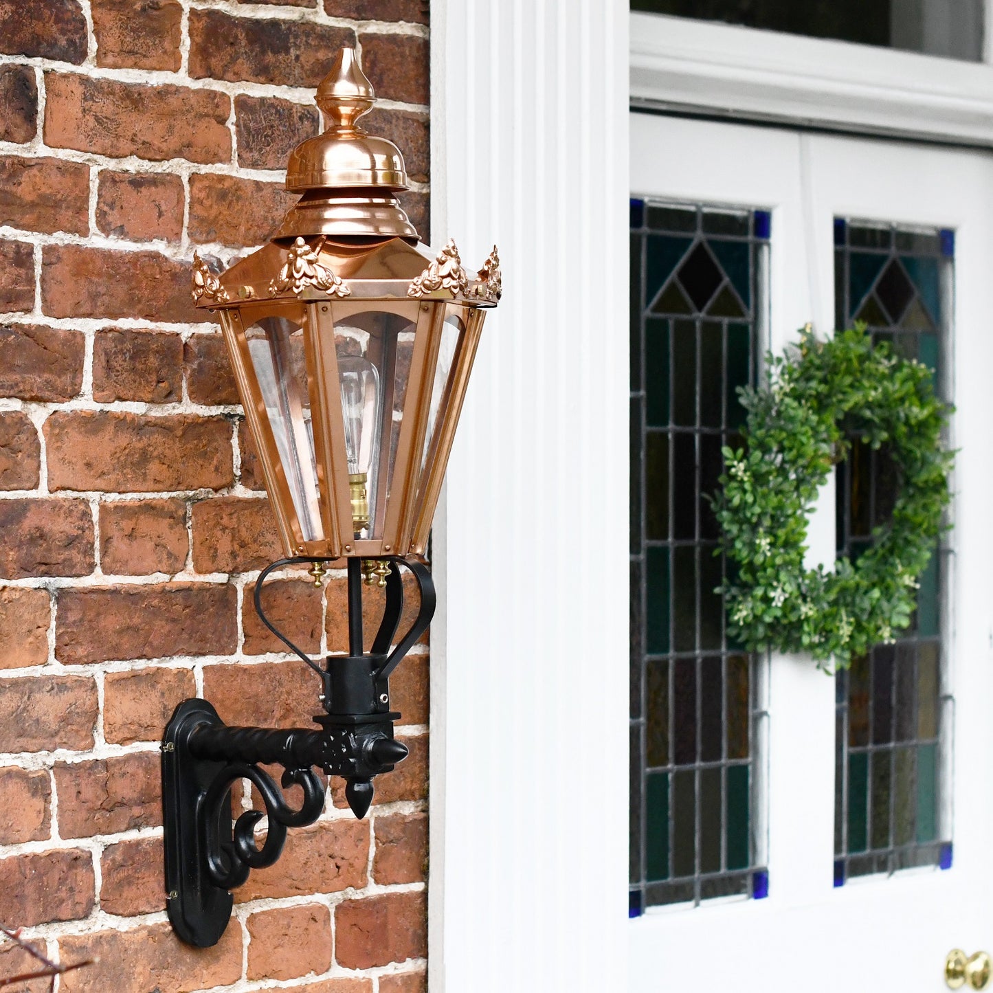 Copper Hexagonal Lantern on Black Scroll Bracket