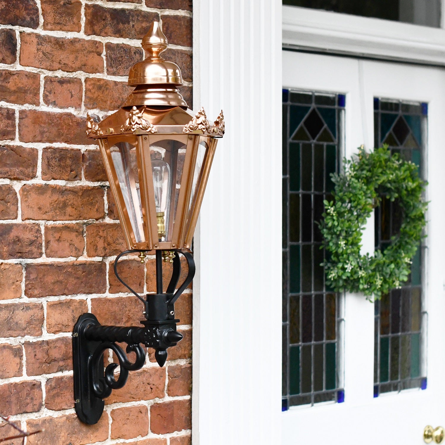 Copper Hexagonal Lantern on Black Scroll Bracket