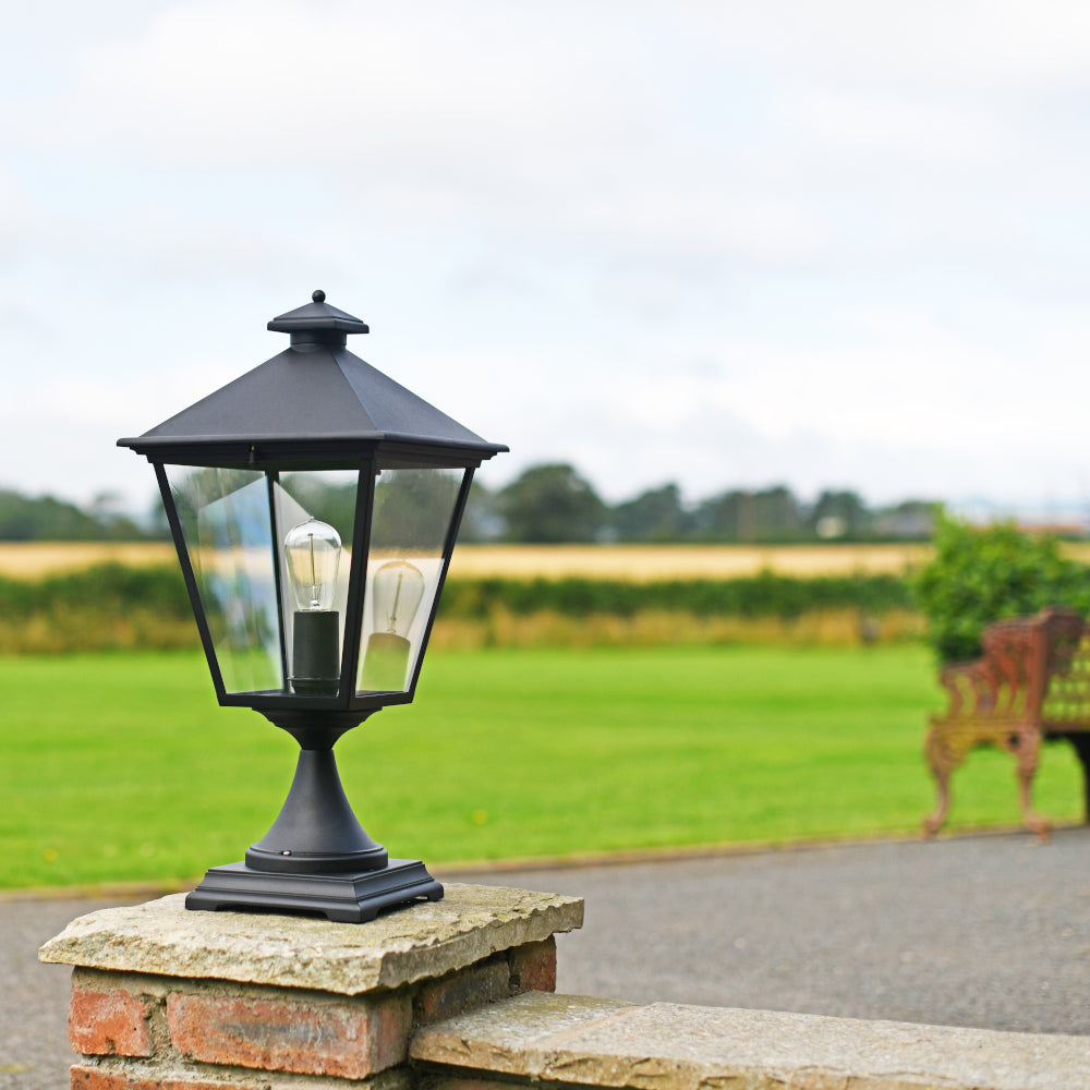 The bold black light placed on an entrance pillar 