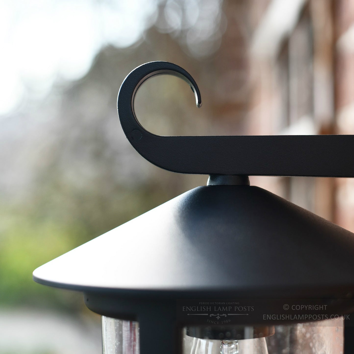 Curled wrought iron lantern bracket
