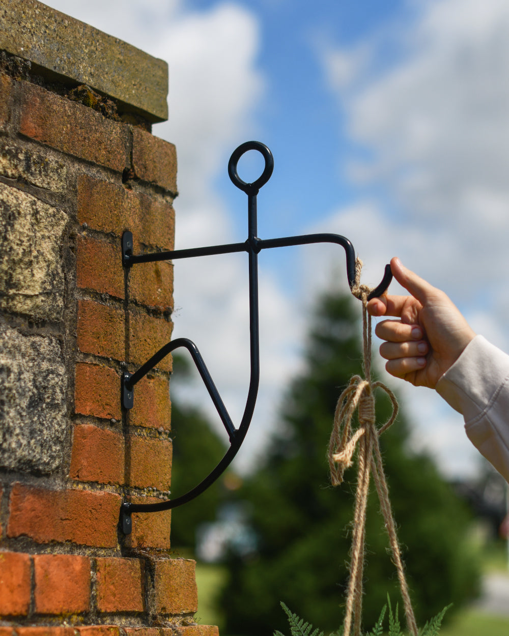 Stick man bracket for hanging basket 