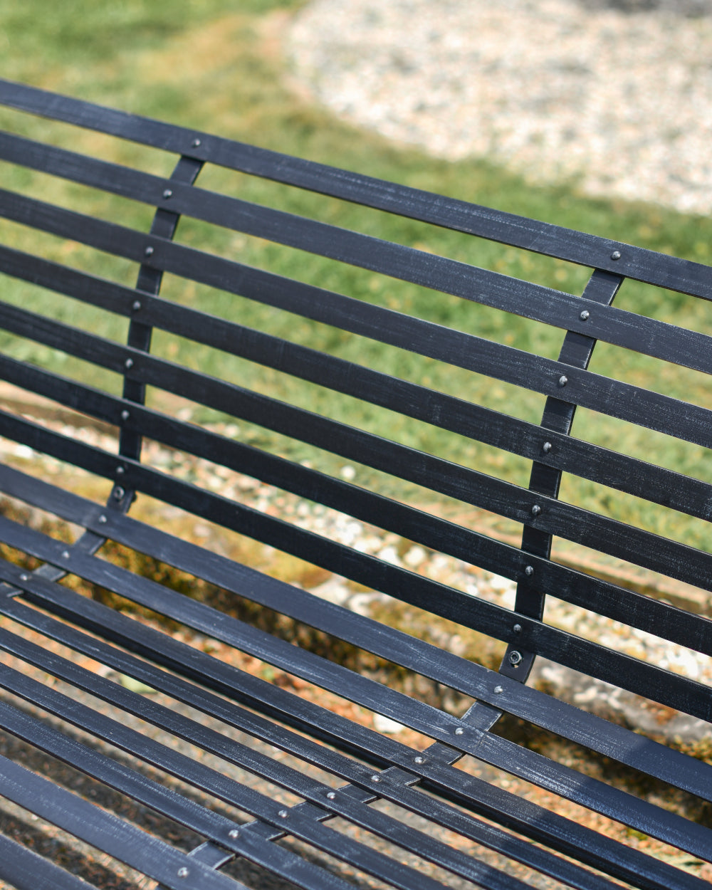 Antique black panelled park bench