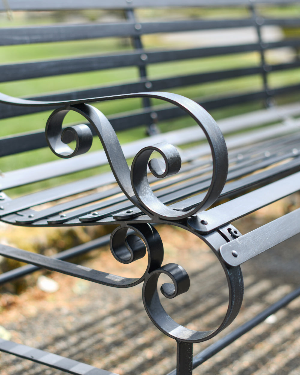 Coiled bench arm rests