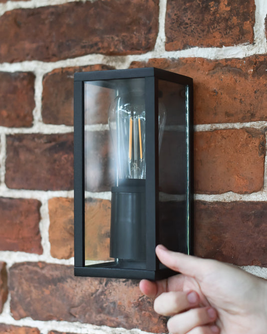 Matte black wall light fixed to a wall 