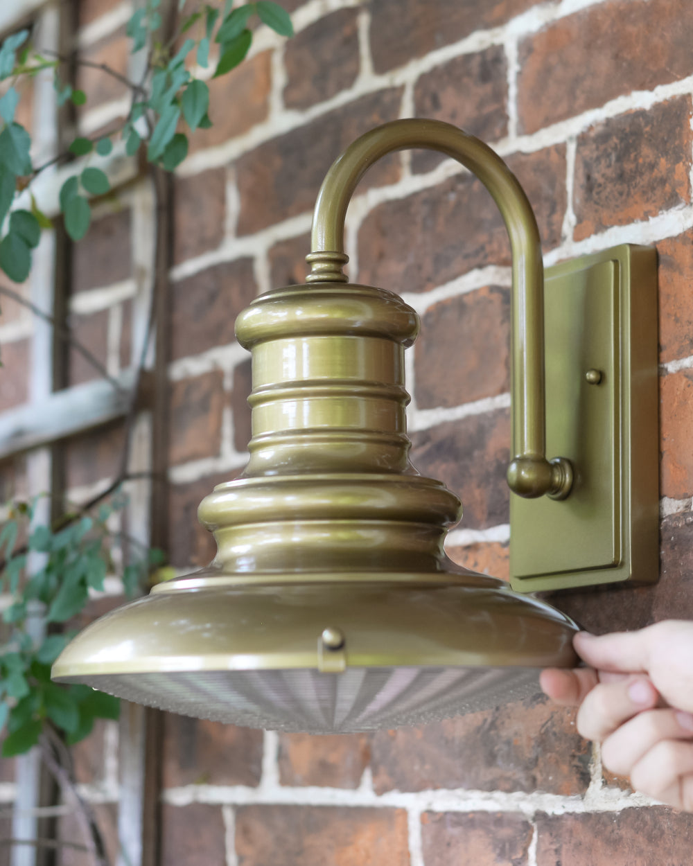 Life-size scale of gold wall light