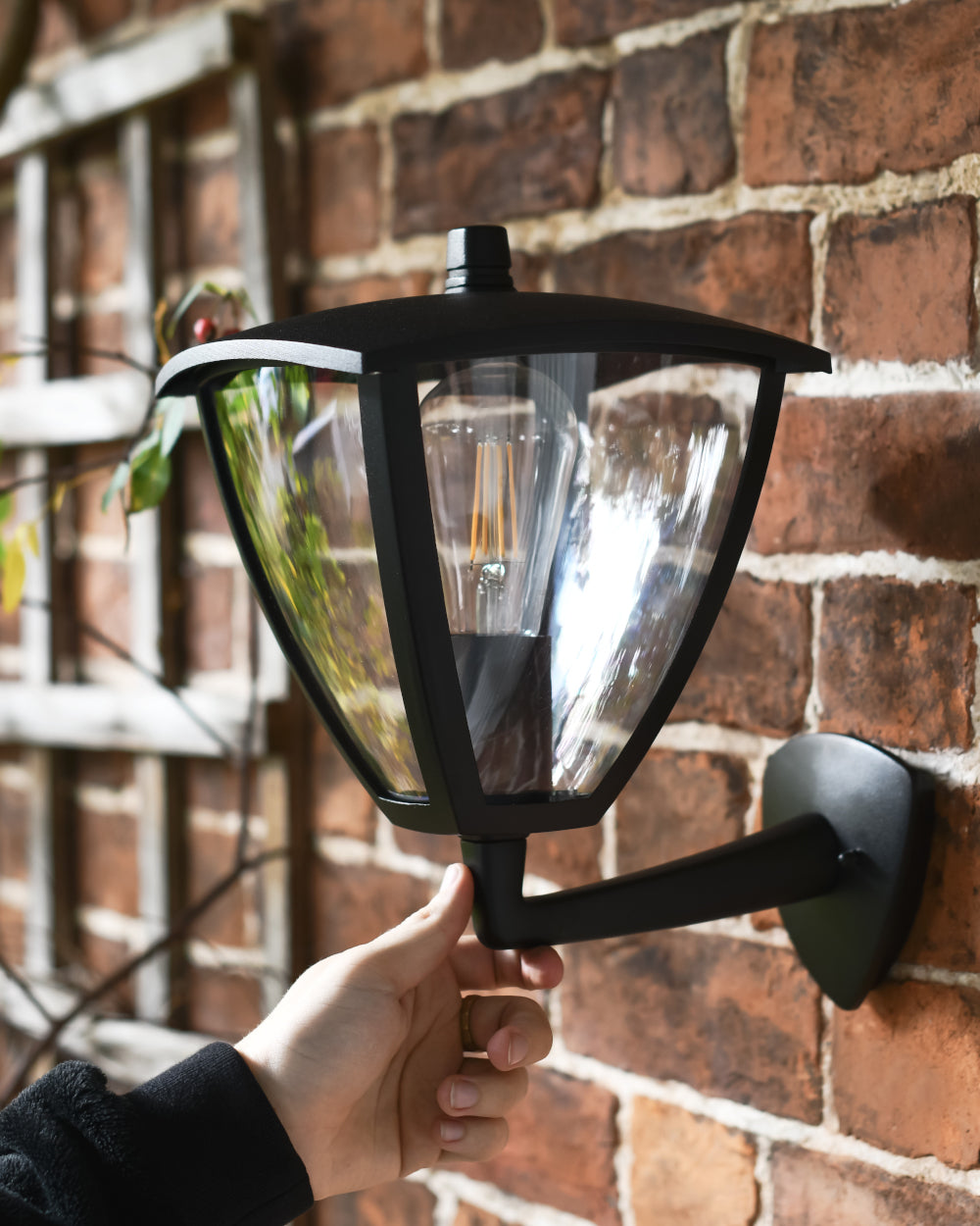 Garden wall light fixed to the front of a house 