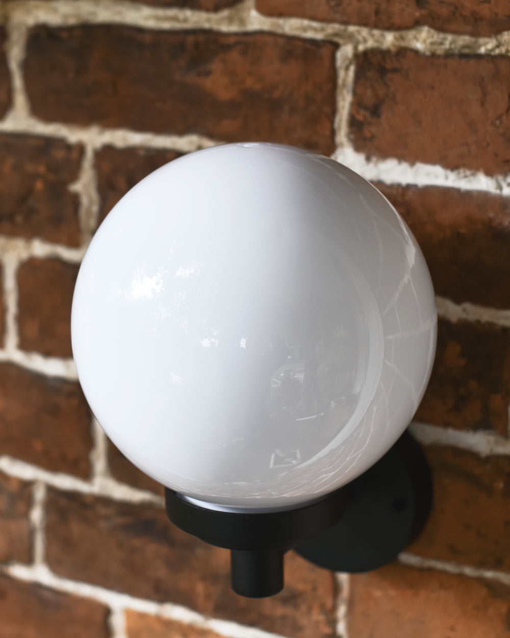 White globe sitting on bottom fix bracket 