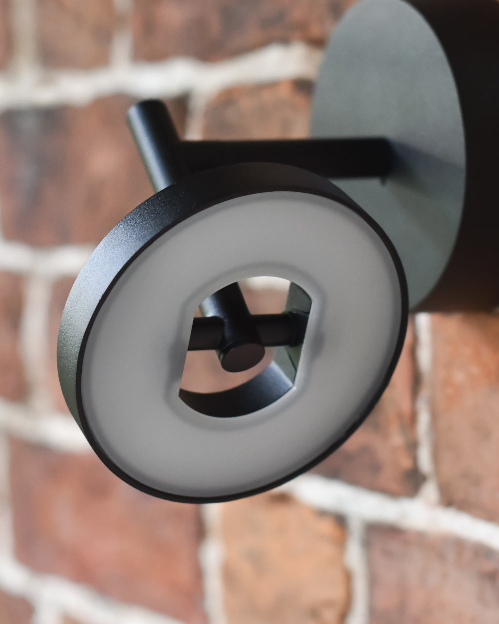 Circular adjustable wall light
