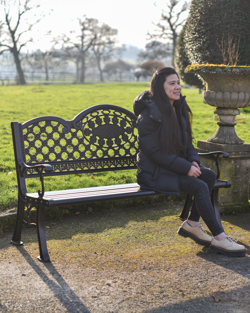 Life-sized model sitting on garden bench