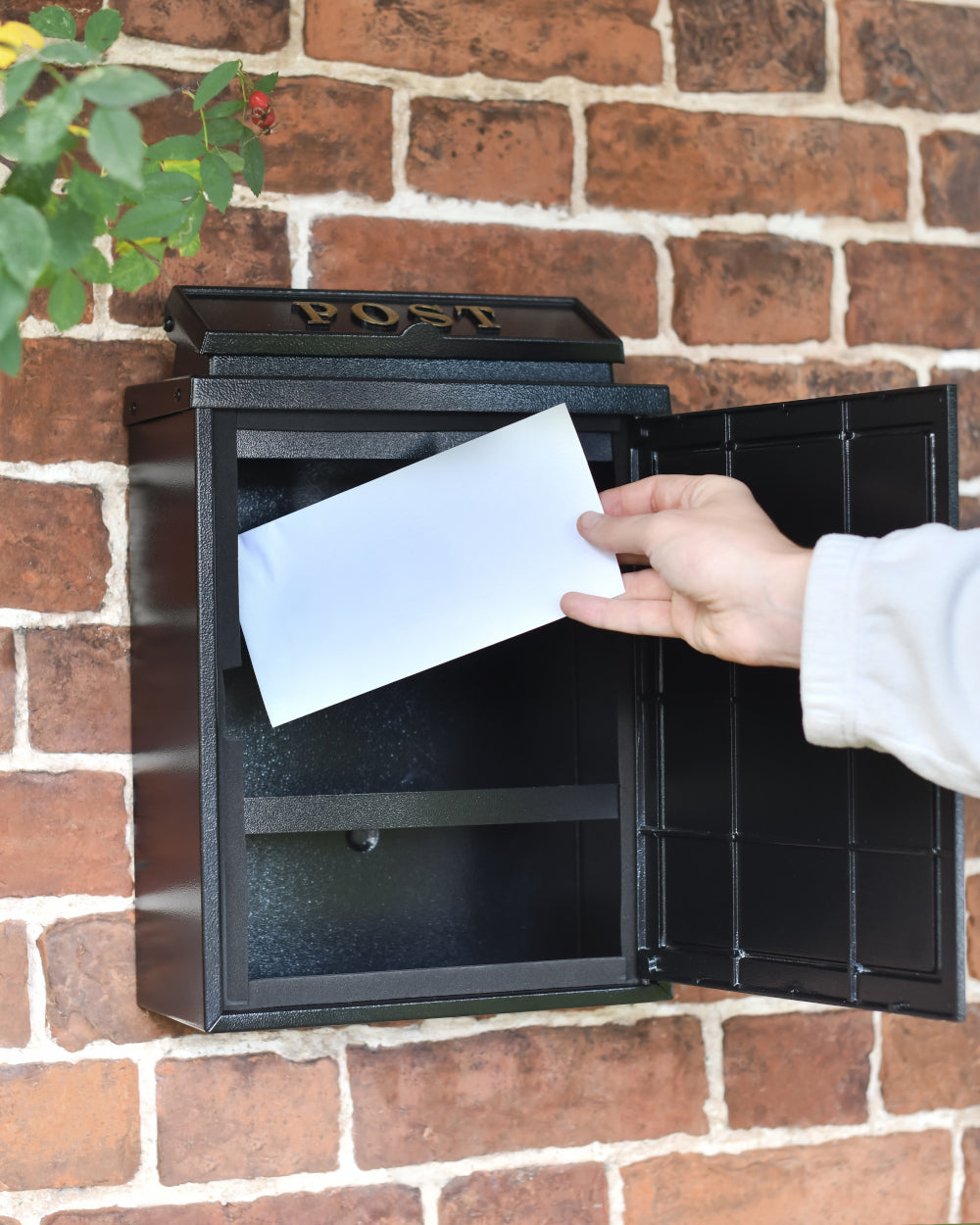 Black post box with retention bar