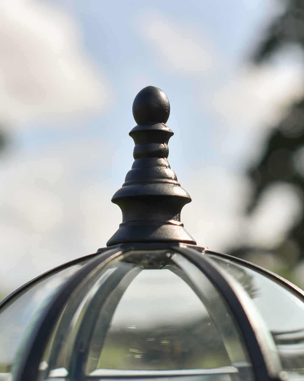 Ornate finish at the top of pillar light 