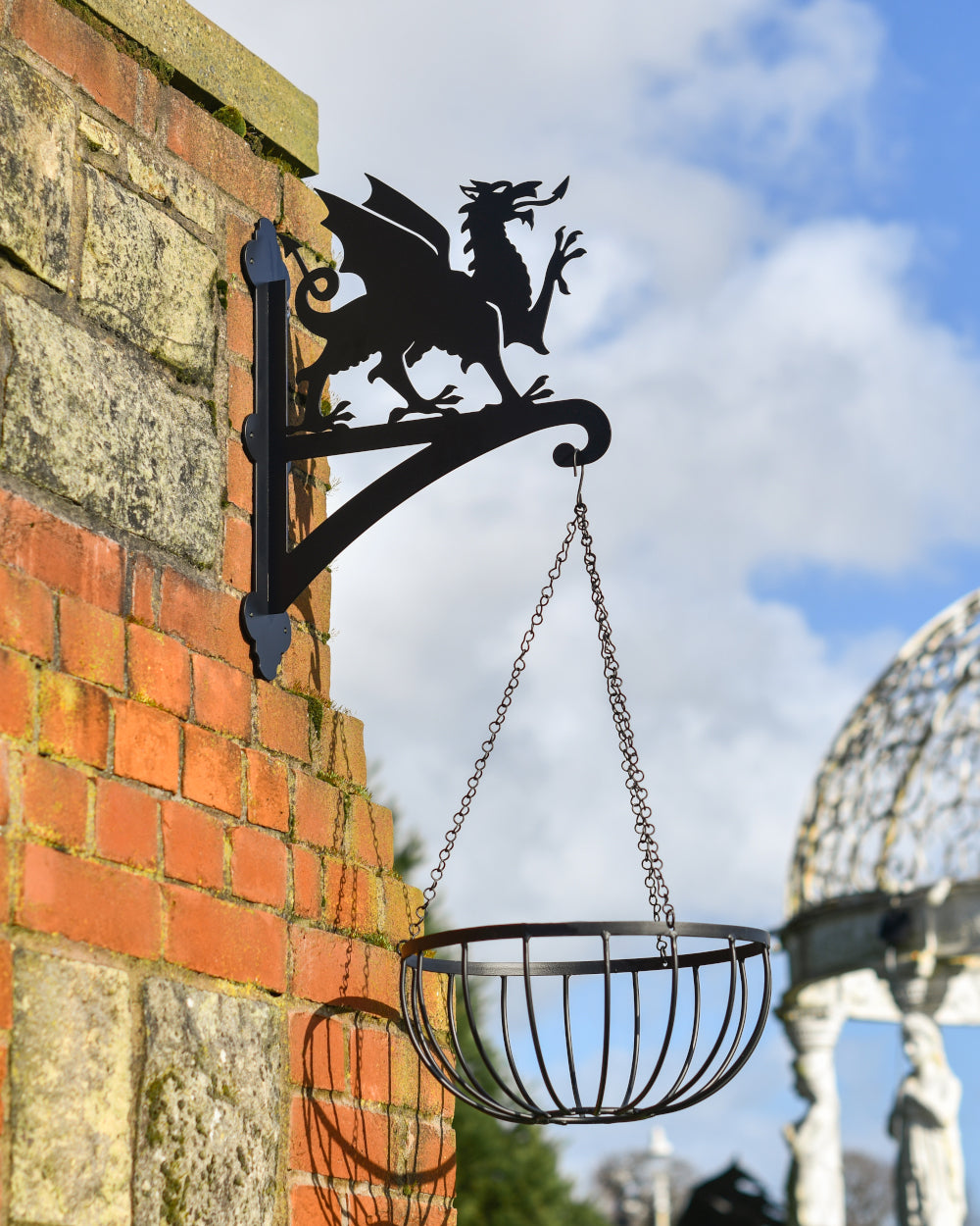 Welsh dragon hanging basket bracket with a basket attached