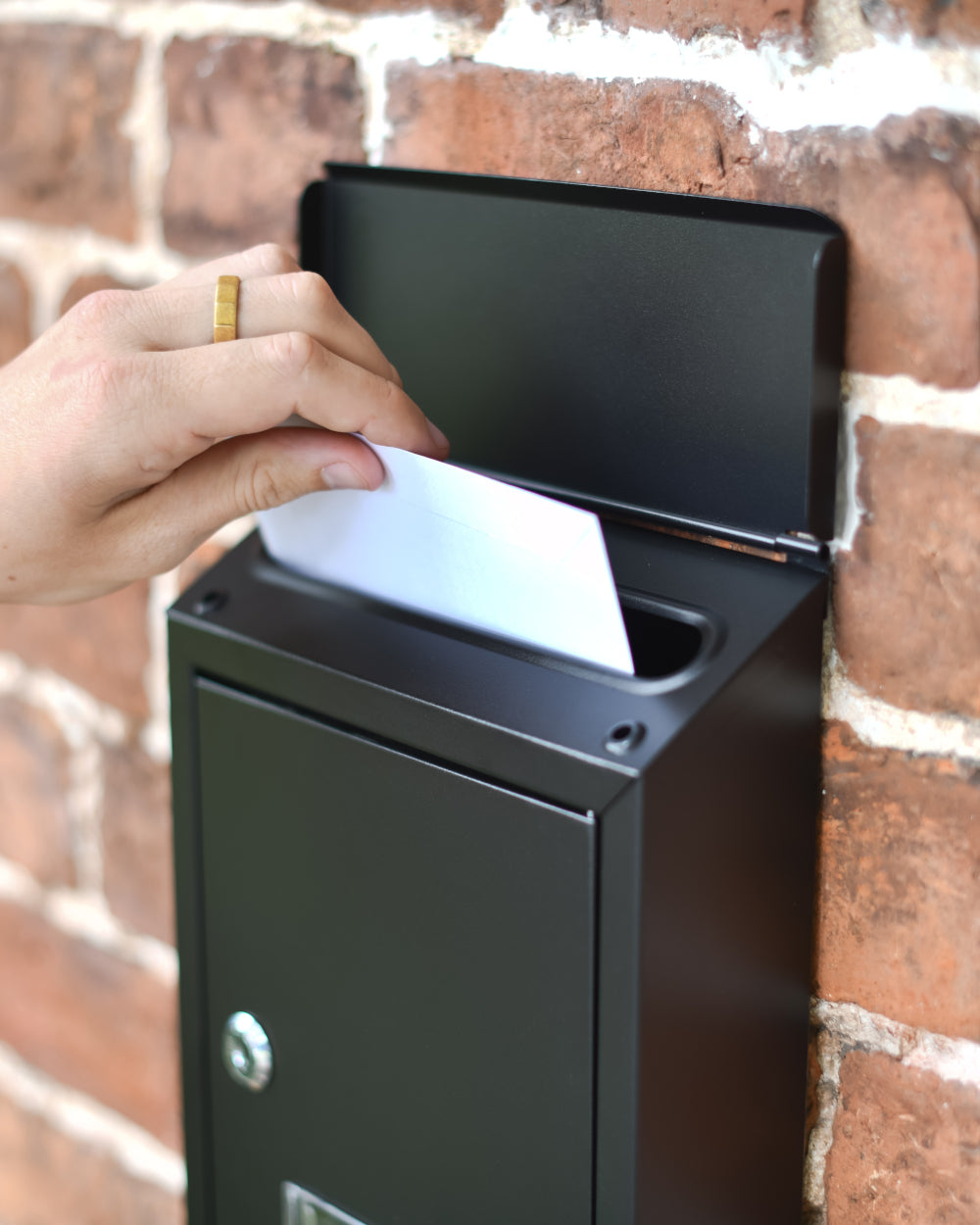 Post box with enclosed postage flap