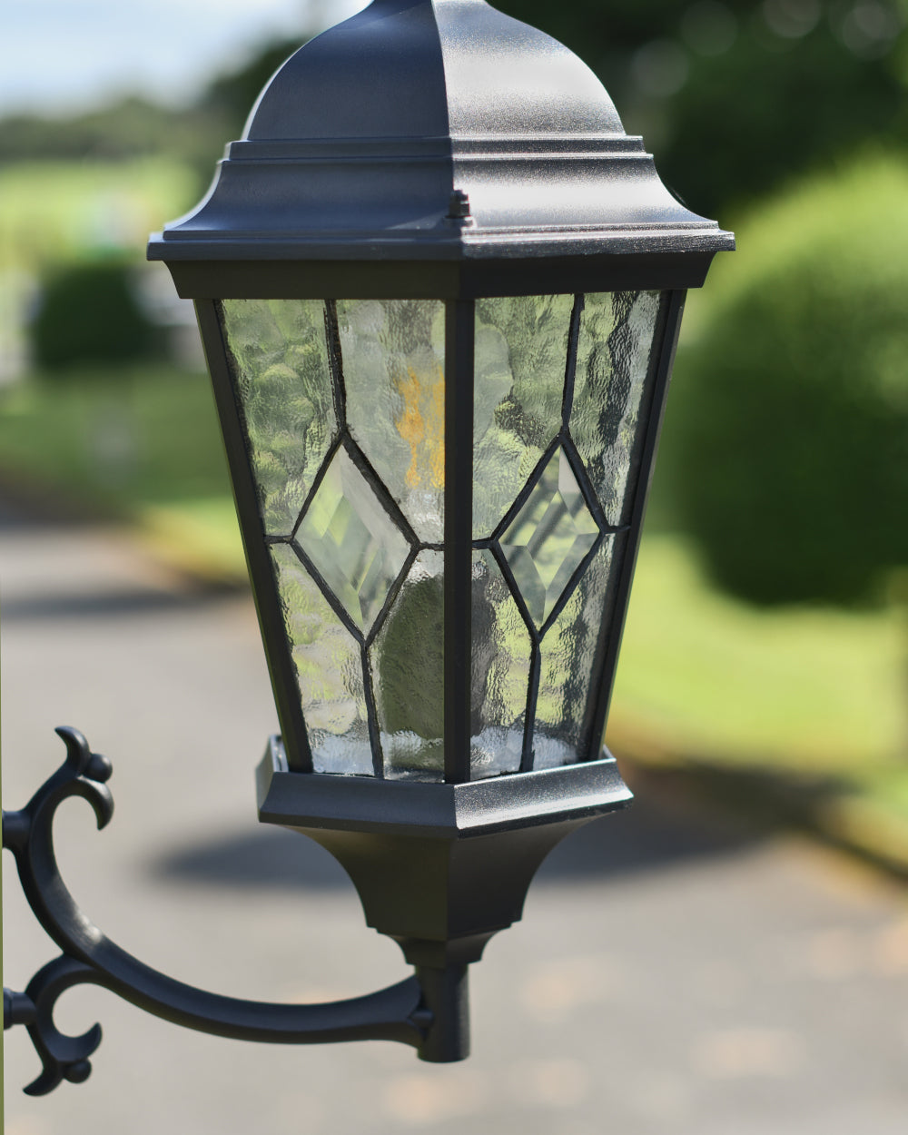 Black lantern on ornate bracket 