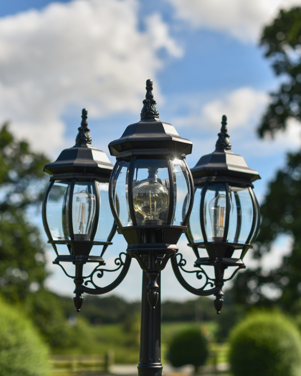 Triple-headed lanterns with clear glass panes 