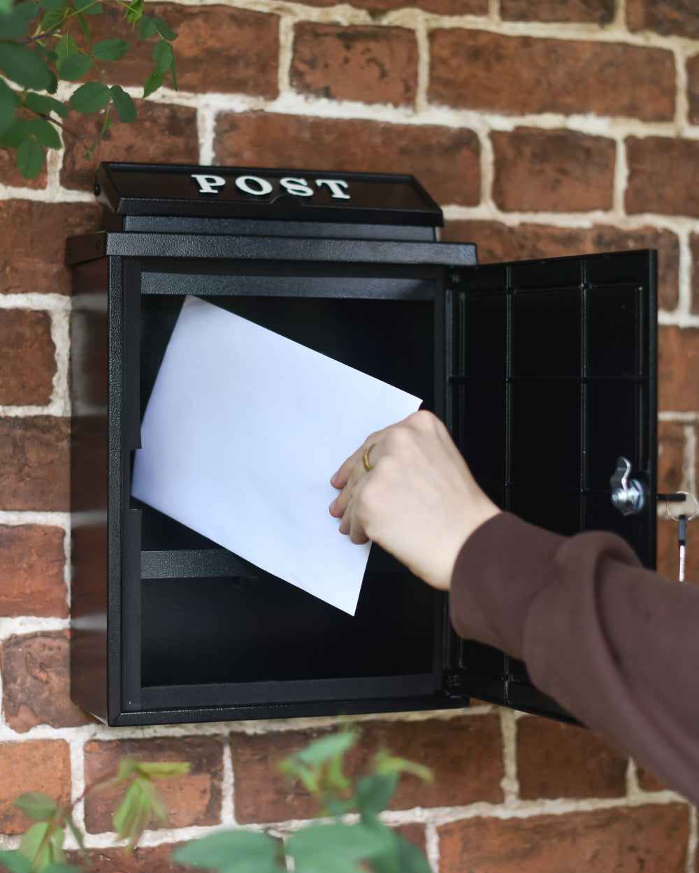 Lockable hinged door letter box