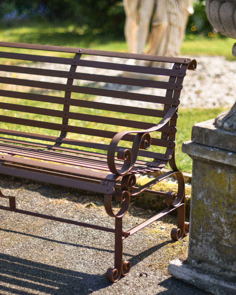 Garden bench with ornate arms 