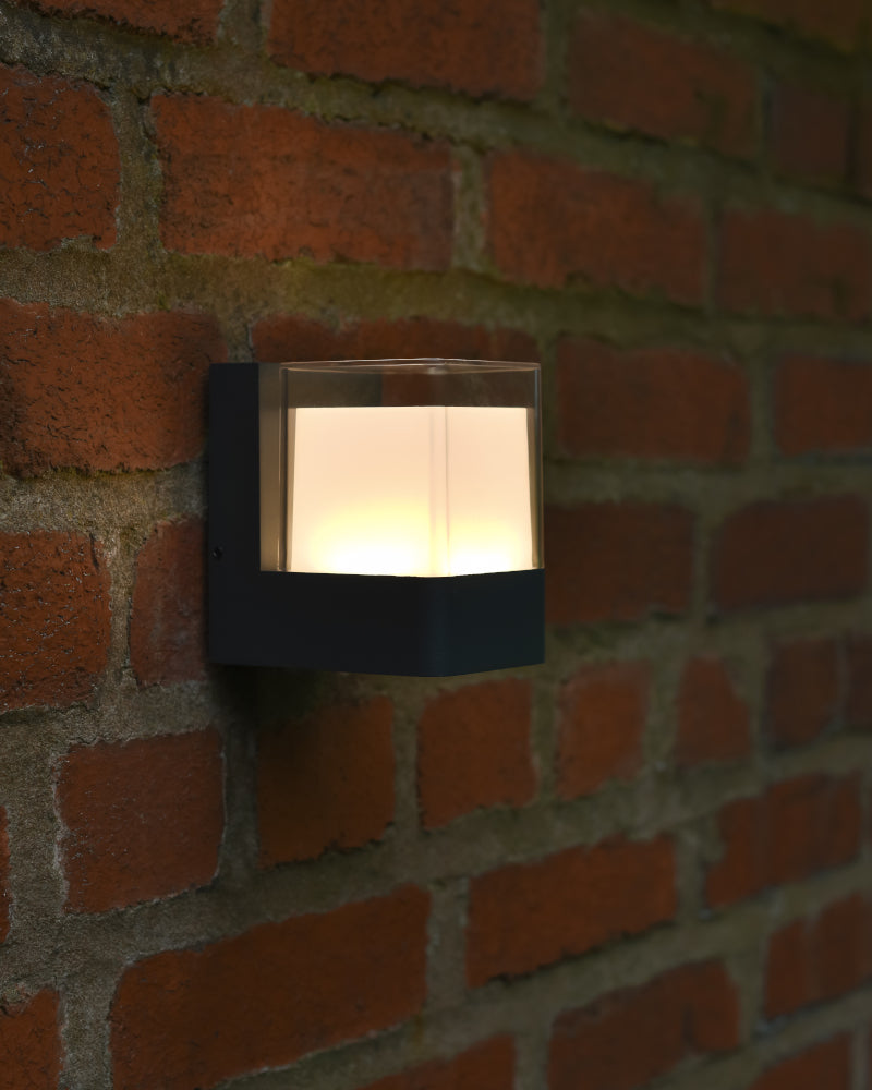 Three quarter view of the flush fit wall light illuminated in the dark